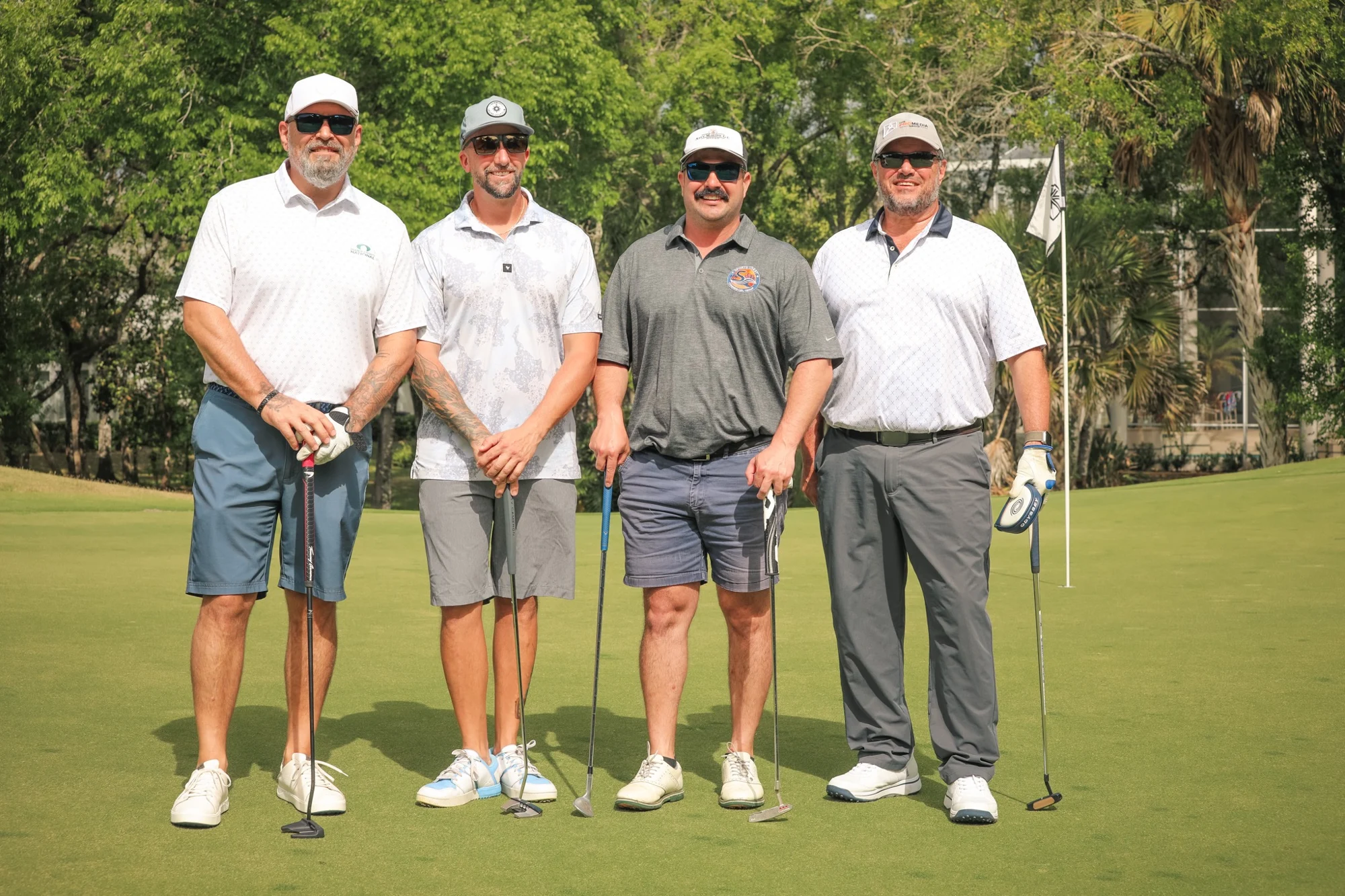 Four golfers posing together